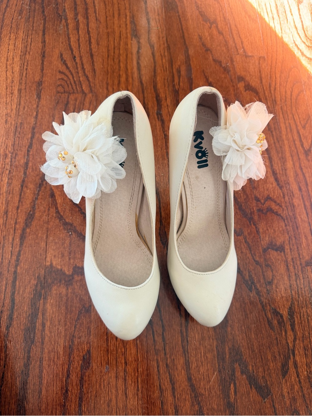 Cream color heels with a flower on the side